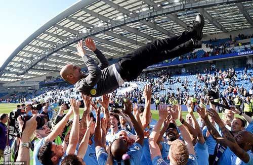 City Coach, Guardiola is thrown into the air after his side beat Brighton 4-1 to finish one point ahead of title rivals Liverpool.