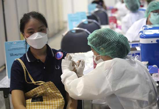 A health worker administers a dose of the Sinovac COVID-19 vaccine to a woman in Bangkok, Thailand, Monday, May 31, 2021. (AP Photo/Sakchai Lalit)