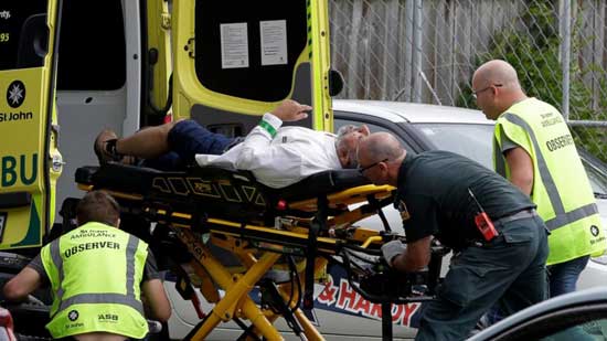(AP)  Ambulance staff take a man from outside a mosque in central Christchurch, New Zealand, Friday, March 15, 2019. A witness says many people have been killed in a mass shooting at a mosque in the New Zealand city of Christchurch.