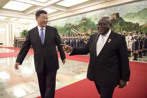 China's President Xi Jinping, left, and Ghana's President Nana Akufo-Addo, right, review the honor guard of Chinese People's Liberation Army during the welcome ceremony at the Great Hall of the People Saturday, Sept. 1, 2018. (Nicolas Asfouri/Pool Photo via AP)